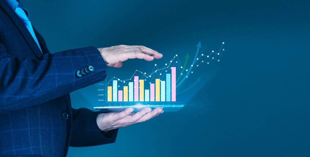 Businessman',Hand,Supports,A,Rising,Graph,On,A,Tablet,,Representing