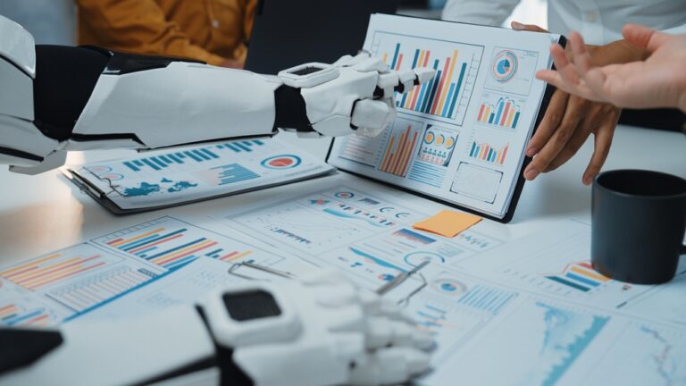 A,Robotic,Arm,Assists,A,Business,Team,In,Analyzing,Data