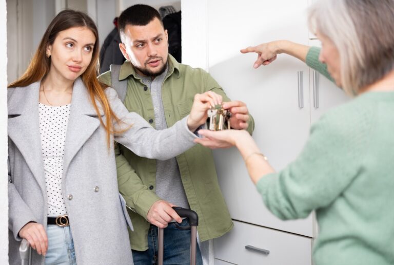 Man,And,Woman,Giving,Back,Apartment,Keys,To,Displeased,Old