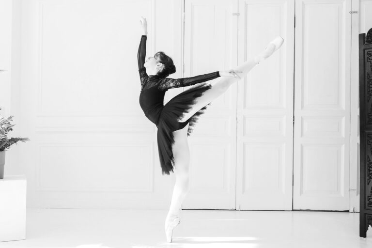 A,Young,Ballerina,In,A,Black,Tutu,Poses,Arabesque,,Total