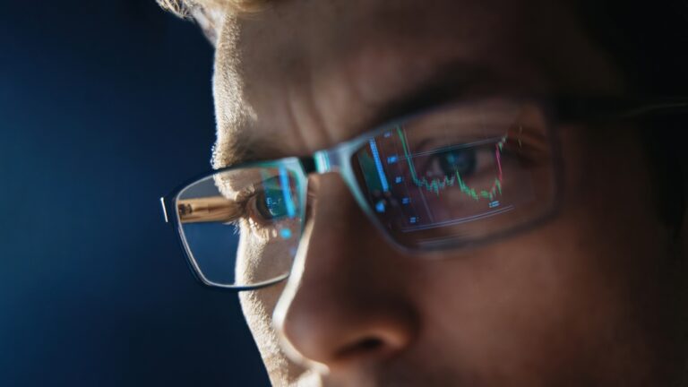 Close,Up,View,Of,Focused,Trader,Wears,Eyeglasses,Looking,At