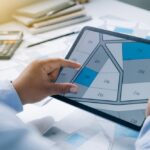 Man,Holding,A,Tablet,Looking,At,Lots,Of,Lands.,Land