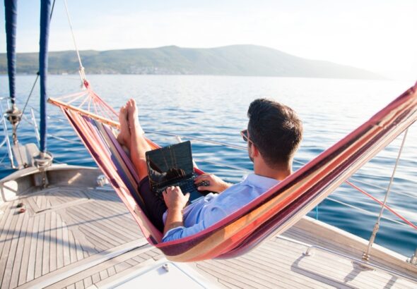 Working,In,Sea,Traveling.,Man,With,Laptop,In,Beach,Hammock.