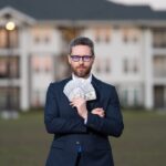 Successful,Realtor,In,Suit,With,Money,Dollar.,House,Owner,Hold