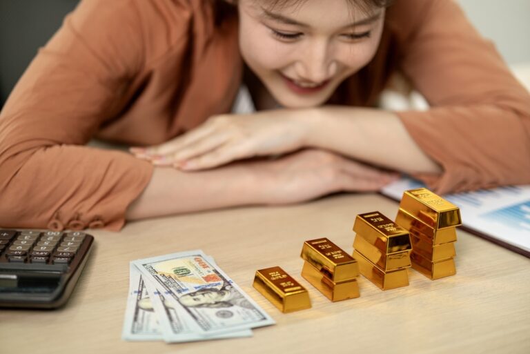 Adult,Asian,Female,Happily,Analyzes,Gold,Investments,Dollars,Calculator,Business