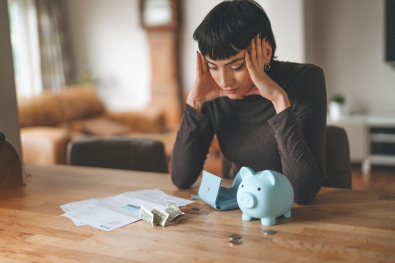 Woman,Stressed,Over,Bills,And,Finances,At,Home,,Sitting,By