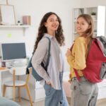 Female,Students,With,Backpacks,In,Dorm,Room