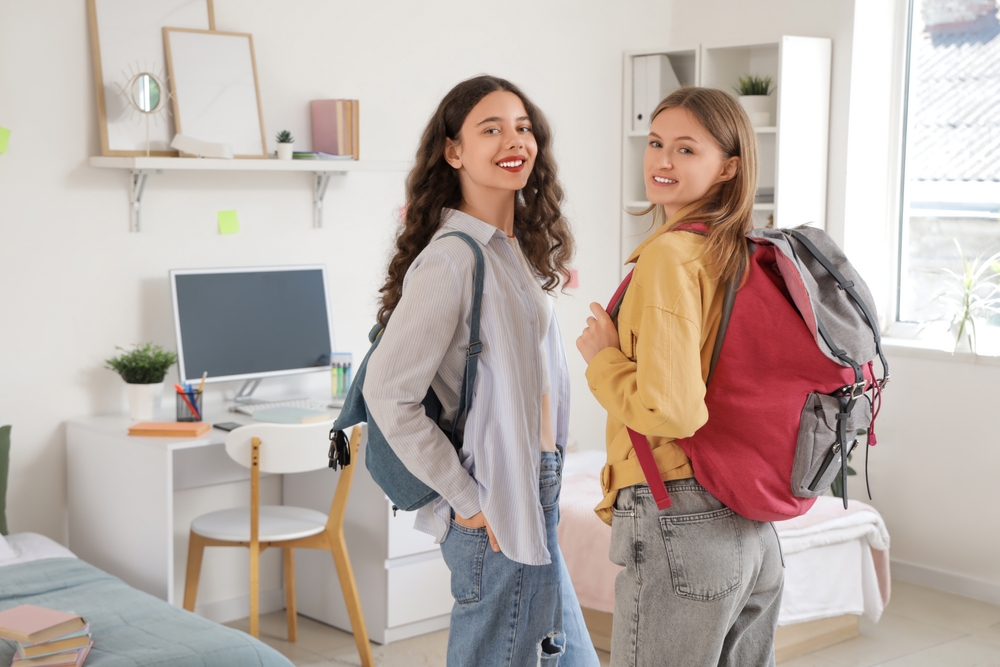 Female,Students,With,Backpacks,In,Dorm,Room