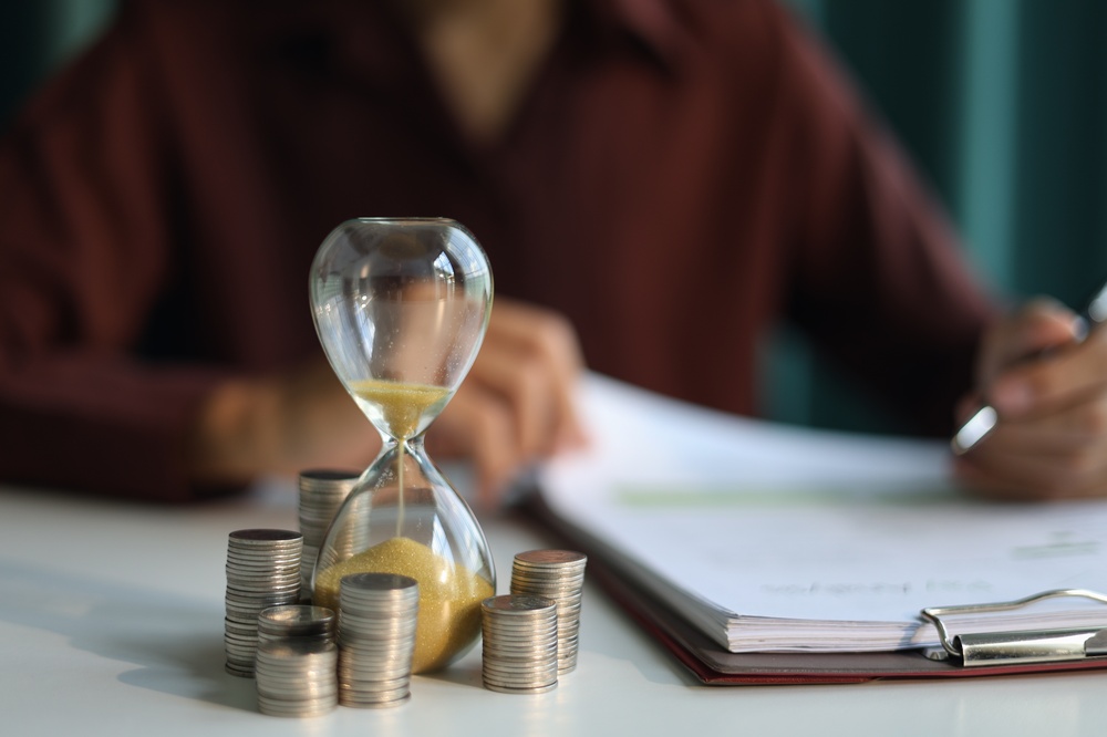 Coin,Stacks,And,Sand,Clock,On,The,Table.,Growing,Of
