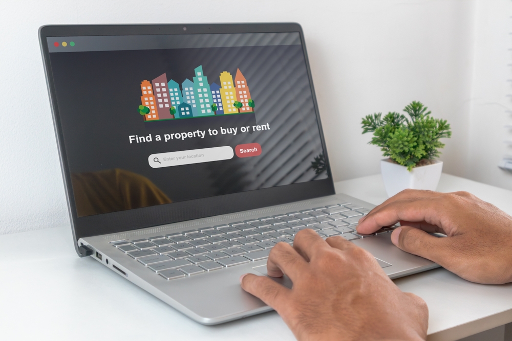 Man,Using,Laptop,To,Searching,For,A,Property,To,Buy