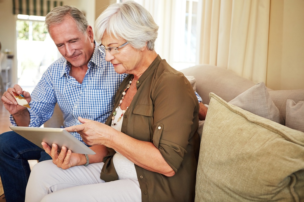 Elderly,Couple,,Tablet,Or,Credit,Card,In,House,For,Ecommerce,