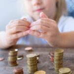 Small,Child,Makes,Roof,Over,Metal,Coins,,Kid,Puts,Euro