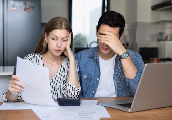 Concerned,Young,Couple,Of,Tenants,,Renters,Checking,Too,High,Paper