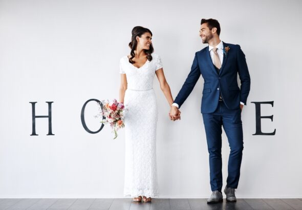 Smile,,Bride,And,Groom,Holding,Hands,In,New,Home,For