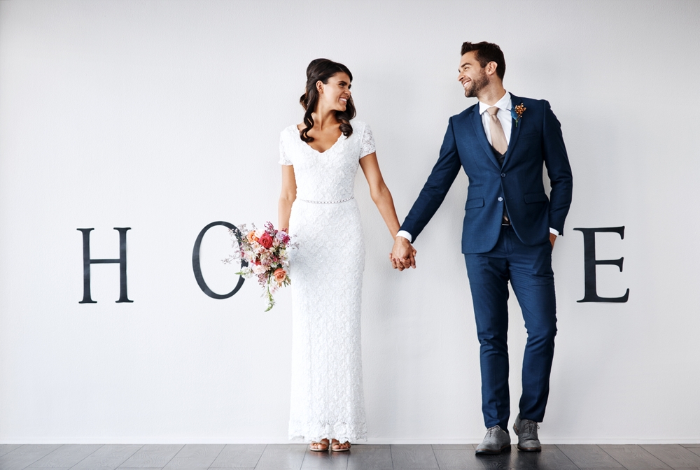 Smile,,Bride,And,Groom,Holding,Hands,In,New,Home,For