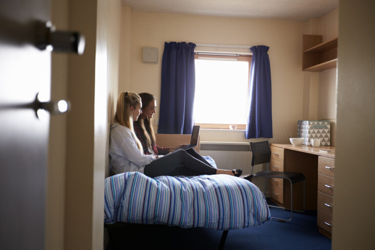 Female,Students,Working,In,Bedroom,Of,Campus,Accommodation
