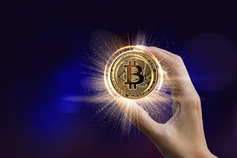 Hand,Holding,Golden,Bitcoin,Isolated,On,Blue,Background