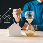 Person,Holds,House,Keys,,Hourglass,Shows,Time,For,Urgent,Real