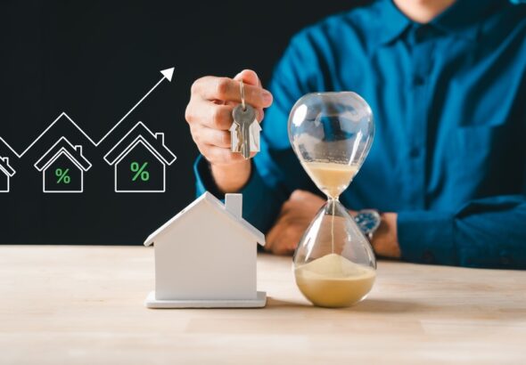 Person,Holds,House,Keys,,Hourglass,Shows,Time,For,Urgent,Real